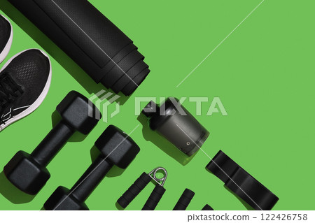 Black workout equipment for training at home on bright green background. Fitness, sport items, healthy lifestyle concept. Copyspace Black workout equipment for training at home on bright green background. Fitness, sport items, healthy lifestyle concept. Copyspace 122426758