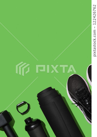 Black workout equipment for training at home on bright green background. Fitness, sport items, healthy lifestyle concept. Copyspace Black workout equipment for training at home on bright green background. Fitness, sport items, healthy lifestyle concept. Copyspace 122426762