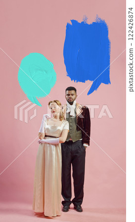 Man in baroque-inspired velvet coat and elegant woman against pink background with speech bubbles for text. 122426874