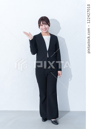 Full body of a young female businessman giving a guide 122427018