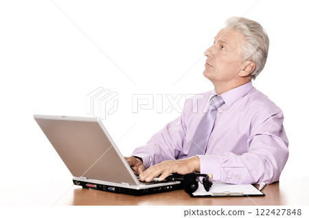Old businessman working with laptop on white background Old businessman working with laptop on white background 122427848