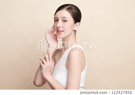 Beautiful young woman with clean fresh skin on beige background, Face care, Facial treatment, Cosmetology, beauty and spa, women portrait. 122427958