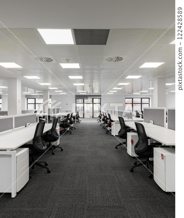 Empty open office space with modern design and ergonomic setup Empty open office space with modern design and ergonomic setup 122428589