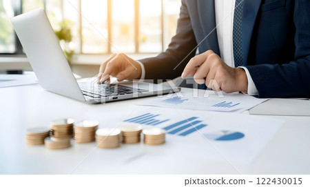 A financial advisor discussing investment strategies with a client in a modern office setting with a laptop and documents 122430015