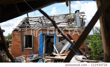 View to destroyed residential buildings at Kharkivska oblast. Ruined houses after bomb attacks on ukrainian territory from russia army. Consequences of russian invasion of Ukraine. Slow motion 122430716