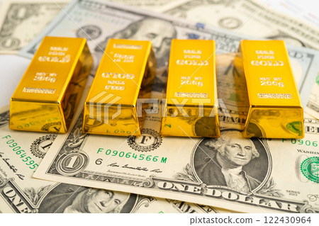 Gold bars with US dollar banknote money, finance trading investment business currency. Gold bars with US dollar banknote money, finance trading investment business currency. 122430964