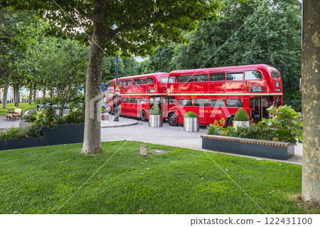 Iconic London Red Buses in a Scenic Park Setting 122431100