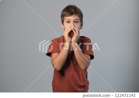 Excited child in terracotta tee makes an announcement. Reflects the innocence of childhood and the pure joy found in simple acts of expression. Excited child in terracotta tee makes an announcement. Reflects the innocence of childhood and the pure joy found in simple acts of expression. 122431142