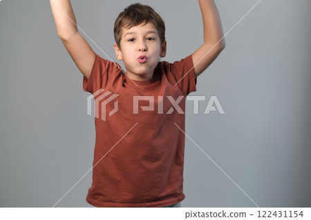 Youngster dramatizes a scare, stretching his eyes in jest. Emphasizes the importance of creativity in youth development and stress relief. 122431154