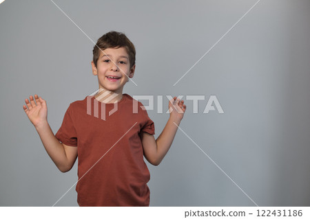 The child's slanted stance and smile radiate playful energy. It reflects the growing appreciation for natural, unposed photography in family albums. 122431186