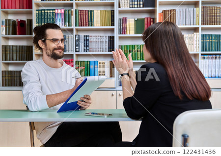 Young male mental health specialist working with mature female patient Young male mental health specialist working with mature female patient 122431436