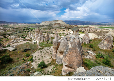 Unique rock formations rise majestically under a dramatic sky in a scenic landscape 122431781