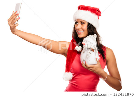 Girl holds snowman taking selfie Girl holds snowman taking selfie 122431970