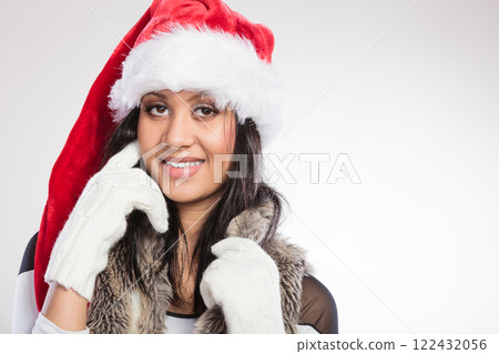 Woman mixed race santa helper hat portrait Woman mixed race santa helper hat portrait 122432056