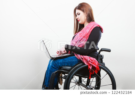 Young girl on wheelchair surfing web. 122432184