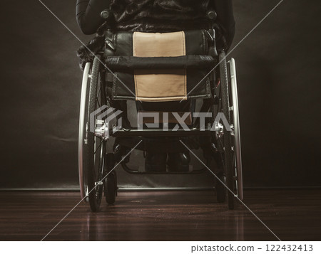 Girl sitting on wheelchair. 122432413