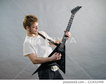 Man playing on electric guitar Man playing on electric guitar 122432499