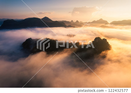 Golden sunrise over foggy mountain in valley at Ban Jabo tribe village Golden sunrise over foggy mountain in valley at Ban Jabo tribe village 122432577