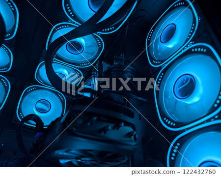 Multiple cooling fans emit blue light, showcasing efficient airflow and design Multiple cooling fans emit blue light, showcasing efficient airflow and design 122432760