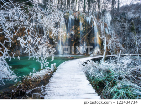 Winter waterfall, frozen bridge and trees, icicles in cold day 122434734