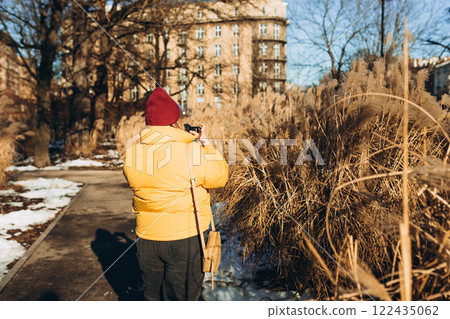 Professional woman photographer taking outdoor portraits with prime lens outdoors. Female taking pictures on vacation. Nature and sunlight. Professional woman photographer taking outdoor portraits with prime lens outdoors. Female taking pictures on vacation. Nature and sunlight. 122435062