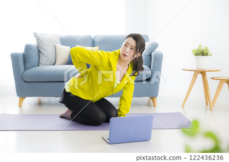 A young woman stretching 122436236