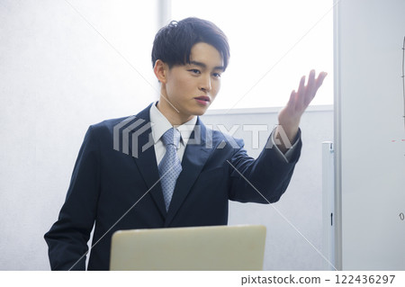 Young businessman presenting Young businessman presenting 122436297