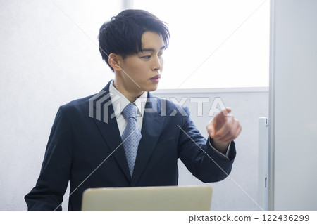 Young businessman presenting Young businessman presenting 122436299