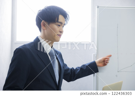 Young businessman presenting Young businessman presenting 122436303