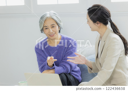 Senior woman and woman in suit having a conversation 122436638