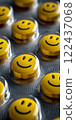 A group of yellow pills with smiling faces on them. happy concept 122437068