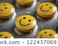 A group of yellow pills with smiling faces on them. happy concept 122437069