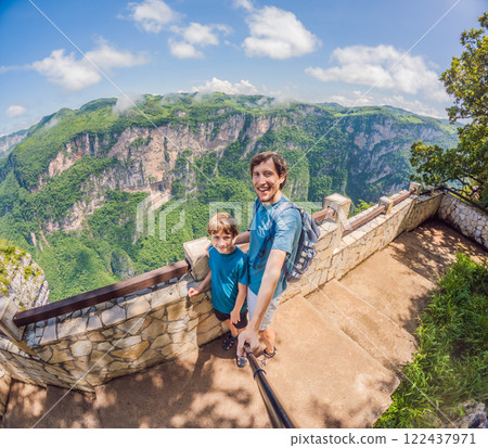 Father and son exploring Sumidero Canyon, Mexico. Family adventure in nature with breathtaking river views, towering cliffs, and lush scenery. Concept of bonding, outdoor exploration, and eco-tourism 122437971