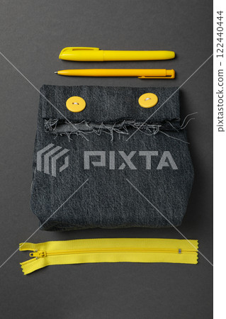 Denim handmade bag, tools and materials on gray background, top view 122440444