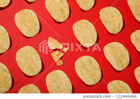Crispy potato chips on a red background Crispy potato chips on a red background 122440464