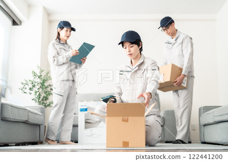 A team of moving company staff packing for a move A team of moving company staff packing for a move 122441200