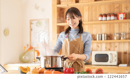 Smiling woman cooking in the kitchen 122441657