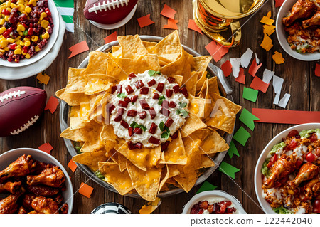 Overhead view of a Super Bowl party spread with nachos and dips Overhead view of a Super Bowl party spread with nachos and dips 122442040