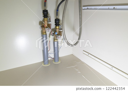 Leaking faucet (actual view under the sink) 122442354