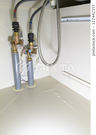 Leaking faucet (actual view under the sink) 122442355