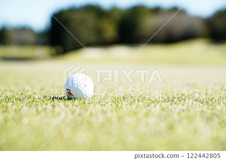 Golf course with golf balls rolling Golf course with golf balls rolling 122442805
