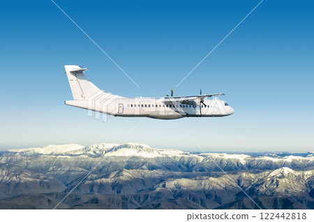 White passenger turboprop airplane fly over snow covered mountains White passenger turboprop airplane fly over snow covered mountains 122442818