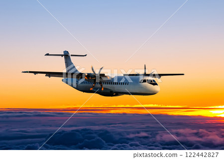 White passenger turboprop aircraft fly in the sunrise sky 122442827