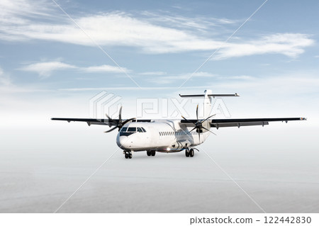 White passenger turboprop aircraft isolated on bright background with sky 122442830
