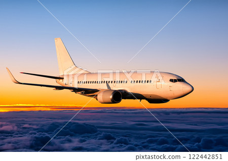 White passenger airplane is flying in the sunrise sky 122442851