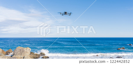 A drone flying over the coast A drone flying over the coast 122442852