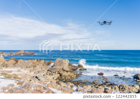 A drone flying over the coast A drone flying over the coast 122442855
