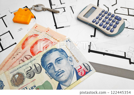 Singaporean Dollar banknotes on the top of building plans Singaporean Dollar banknotes on the top of building plans 122445354