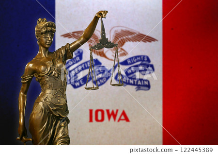 Lady Justice before a flag of Iowa 122445389