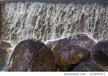 Small waterfall from the artificial basin of a river 122445411